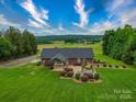 Aerial view of a beautiful home featuring a large backyard and covered patio at 1060 S Lentz Harness Shop Rd, Mount Pleasant, NC 28124