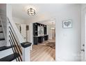 Inviting foyer with hardwood floors, a staircase, and view into the living spaces at 1119 Thornsby Ln, Matthews, NC 28105