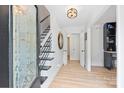 Bright foyer with hardwood floors, staircase, and decorative glass front door at 1119 Thornsby Ln, Matthews, NC 28105