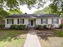 Charming one-story home featuring a symmetrical design, manicured landscaping, and inviting walkway at 121 Patrick St, Gastonia, NC 28054