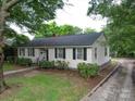 Low angle view of cozy one-story home with a well-maintained lawn and driveway at 121 Patrick St, Gastonia, NC 28054
