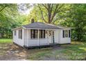 Well-kept one-story home with a charming porch, black shutters and inviting curb appeal at 143 Hallman St, Cherryville, NC 28021
