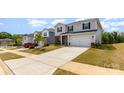 View of a home with a two-car garage and driveway in a suburban community at 164 Shepherds Landing Dr, Mooresville, NC 28115