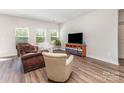 Bright living room with neutral walls, wood floors, and comfortable seating arrangement at 164 Shepherds Landing Dr, Mooresville, NC 28115