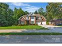 Charming two-story brick home with a well-kept lawn and mature trees, providing curb appeal at 1747 30Th Avenue Ne Dr, Hickory, NC 28601