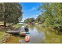 Picturesque waterfront view with a private dock and boats, surrounded by trees at 2010 Dogwood Trl, Shelby, NC 28150