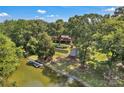 Waterfront home surrounded by mature trees, featuring a private dock and outdoor space at 2010 Dogwood Trl, Shelby, NC 28150