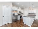 Stylish kitchen featuring stainless steel appliances, white cabinetry, and a large refrigerator at 2039 Sadler Woods Ln, Charlotte, NC 28214