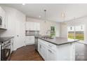 Modern kitchen with white cabinets, granite countertops, stainless appliances and island at 2039 Sadler Woods Ln, Charlotte, NC 28214
