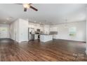 Open-concept kitchen features an island, stainless steel appliances, and hardwood floors at 2047 Sadler Woods Ln, Charlotte, NC 28214