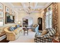 A quaint living room showcasing elegant decor, including floral curtains and checkered armchairs at 2240 La Maison Dr, Charlotte, NC 28226
