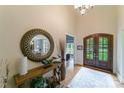Grand foyer featuring a high ceiling, beautiful hardwood floors, and elegant double doors at 2314 Winding Oaks Trl, Waxhaw, NC 28173
