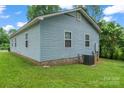 Exterior view of the home with light blue siding and green grass at 301 Honeywood Ave, Charlotte, NC 28216