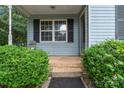Inviting front porch entrance with steps, brick border, and well-manicured bushes at 301 Honeywood Ave, Charlotte, NC 28216