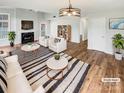 Bright living room with fireplace, modern furnishings, and hardwood flooring at 3436 Ibis Ln, Fort Mill, SC 29707
