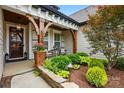 Cozy front porch with seating area, detailed wood accents, and manicured landscaping at 5357 Pembrey Dr, Denver, NC 28037