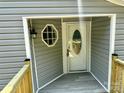 Close-up of front entry featuring a decorative glass door and gray vinyl siding at 5458 Foxcroft Dr, Fort Lawn, SC 29714
