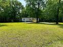 Expansive green front yard surrounding a home with mature trees and a long driveway at 5458 Foxcroft Dr, Fort Lawn, SC 29714