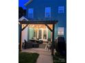 Relaxing outdoor patio with string lights, stylish furniture, and an outdoor grill for entertaining guests at 7931 Baylis Dr, Huntersville, NC 28078