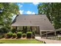 Charming home with a well-maintained lawn and welcoming front entrance with mature trees at 812 Bell Post Rd, Belmont, NC 28012