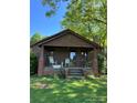 Cozy front porch with rocking chairs, inviting guests to relax and enjoy the peaceful surroundings of this charming bungalow at 850 And 830 E Nc 152 E Hwy, China Grove, NC 28023
