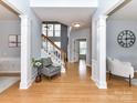 Inviting foyer with hardwood floors, elegant columns, and a staircase at 8608 Talbert Paige Ct, Charlotte, NC 28277