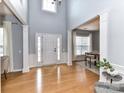 Spacious foyer featuring a tall ceiling, hardwood floors, and natural light at 8608 Talbert Paige Ct, Charlotte, NC 28277