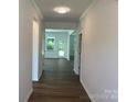 Bright hallway with elegant trim and hardwood floors leading to sunlit rooms in the home at 9108 Dulwich Dr # Ken0074, Charlotte, NC 28215