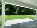 Covered patio with concrete flooring overlooking a lush green backyard, perfect for outdoor relaxation at 9108 Dulwich Dr # Ken0074, Charlotte, NC 28215