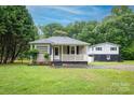 Inviting exterior view of home with a well-maintained lawn and covered front porch at 1036 20Th Ne St, Hickory, NC 28601