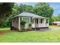 Exterior view of charming home with small garden and a cozy covered porch at 1036 20Th Ne St, Hickory, NC 28601
