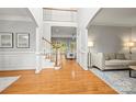 Bright living room featuring hardwood floors, staircase, and a comfortable seating area at 11139 Tradition View Dr, Charlotte, NC 28269