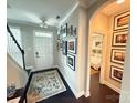Inviting entryway featuring a staircase, dark wood floors, and neutral wall color with art at 114 Mint Ave # A, Mooresville, NC 28117