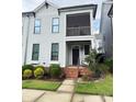 Charming two-story townhome with a screened porch, front entrance, and small front yard at 114 Mint Ave # A, Mooresville, NC 28117