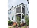 Exterior view of a townhome featuring a screened porch, front entrance, and landscaping at 114 Mint Ave # A, Mooresville, NC 28117