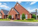 Attractive brick home featuring lush landscaping and a well-maintained lawn at 1302 Warrington Pl, Rock Hill, SC 29732