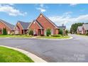 Beautiful brick home with a well-kept lawn and landscaping, creating a welcoming view at 1302 Warrington Pl, Rock Hill, SC 29732