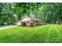 Well-maintained home with a brick facade, attached garage, and green lawn at 1304 5Th Street Nw Cir, Hickory, NC 28601