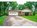 Attached garage with a concrete driveway and well-kept lawn and landscaping at 1304 5Th Street Nw Cir, Hickory, NC 28601