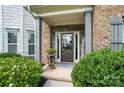 Covered entryway to beautiful home with brick and stone accents at 16229 Loch Raven Rd, Huntersville, NC 28078