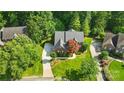 Spacious home with lush greenery, concrete driveway, and mature trees at 1720 Mountain Park Dr, Charlotte, NC 28214