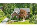 Charming two-story brick home featuring a well-manicured lawn and mature trees at 1720 Mountain Park Dr, Charlotte, NC 28214