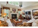 Bright living room with fireplace, large windows, and ample seating, perfect for entertaining or relaxation at 1720 Mountain Park Dr, Charlotte, NC 28214
