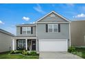 Two-story home with a gray exterior, a two-car garage, and a covered front porch area at 2013 Eastway Dr, Dallas, NC 28034
