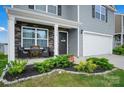 Inviting front porch with stone accents, a cozy seating area, and lush landscaping at 2013 Eastway Dr, Dallas, NC 28034