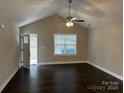 Bright living room featuring hardwood floors, ceiling fan, and natural light from the window at 207 Bennett St, Wadesboro, NC 28170