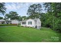 Well-maintained home showcasing a spacious yard, tidy landscaping, and a crisp, white exterior at 2108 Twin Ave, Gastonia, NC 28052