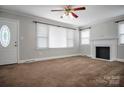 Inviting living room with neutral walls, plush carpeting, a fireplace, and ample natural light at 2108 Twin Ave, Gastonia, NC 28052