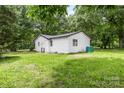 Spacious backyard featuring a white outbuilding and lush lawn at 2280 Cannon Farm Rd, China Grove, NC 28023