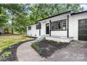 Stylish home featuring a renovated white brick exterior and landscaped walkway at 2280 Cannon Farm Rd, China Grove, NC 28023